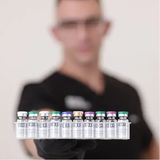 Close-up of a healthcare professional holding a tray of vitamin B12 injection vials at 5 Star Fitnes.